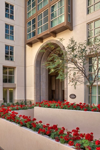 Exterior photo of apartments with planter and flowers